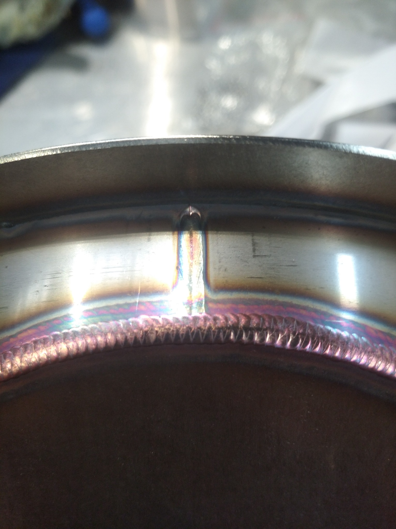 Szczegółowe zbliżenie spoiny na metalowym elemencie wykonanej w Orzeszu, widoczne charakterystyczne zabarwienia termiczne.