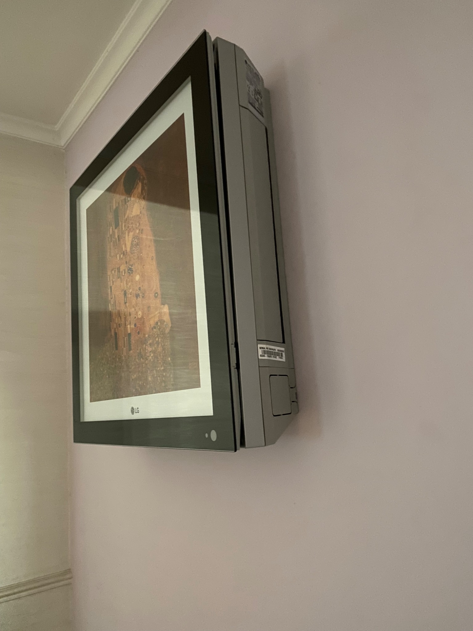 Klimatyzator LG Artcool Gallery zamontowany na ścianie w pokoju, z wyświetlanym obrazem 'Pocałunek' Gustava Klimta.