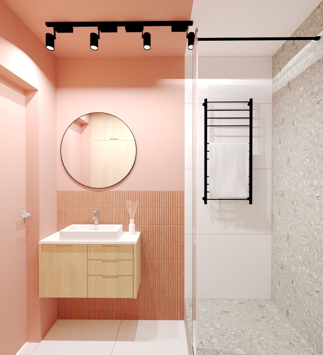Nowoczesna łazienka w odcieniach różu z drewnianą szafką pod umywalką, okrągłym lustrem i czarnym grzejnikiem drabinkowym z białym ręcznikiem.