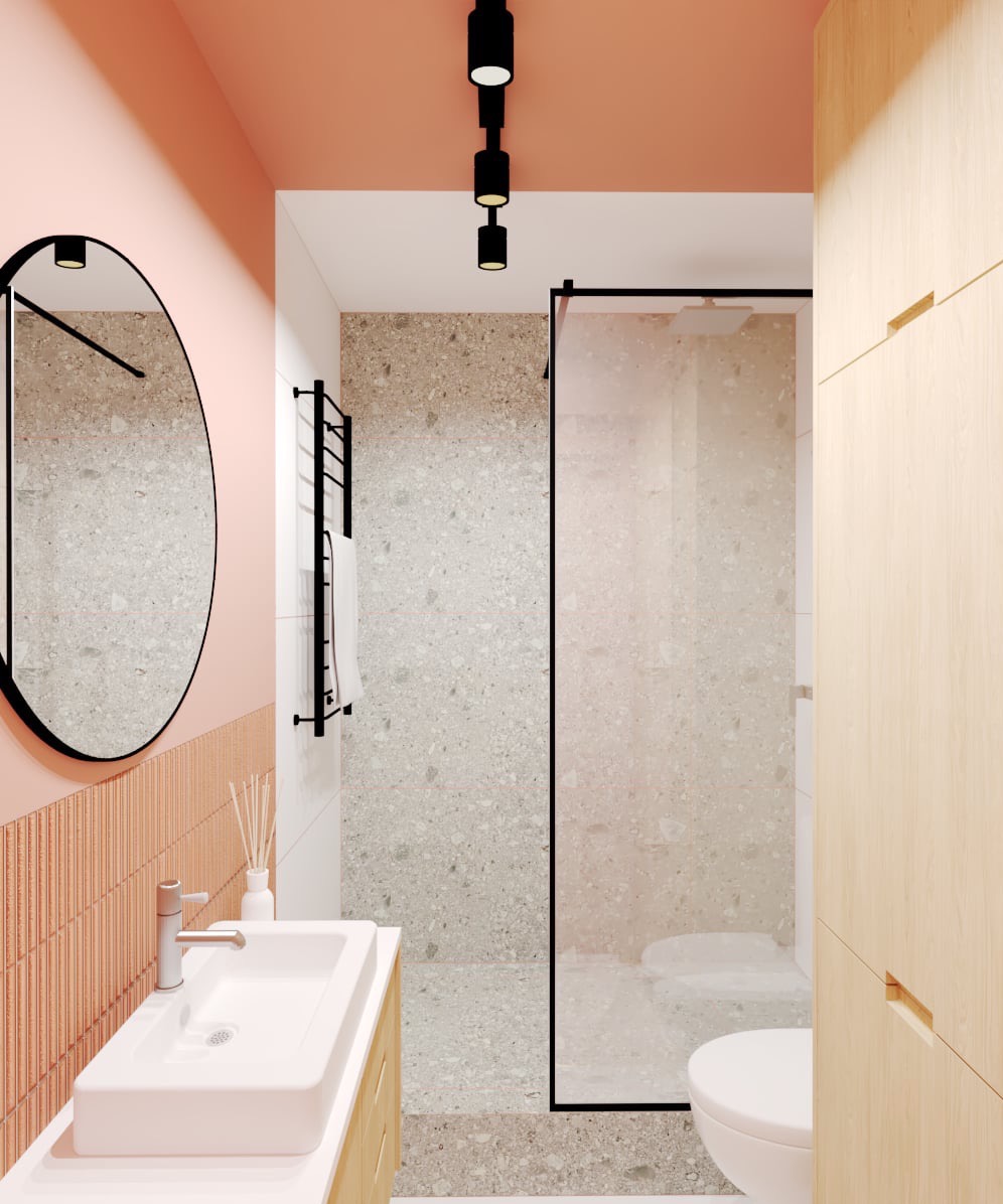 Nowoczesna łazienka z umywalką nablatową, okrągłym lustrem w czarnej ramie, kabiną prysznicową walk-in z czarnymi profilami i armaturą w kolorze chromu, oraz płytkami imitującymi lastryko.