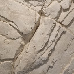 STRUKTURY WROCŁAW SPÓŁKA Z OGRANICZONĄ ODPOWIEDZIALNOŚCIĄ - Jasna ściana z efektem skały, imitująca naturalny kamień. Wyraźna faktura, nieregularne kształty i delikatne cieniowanie. Dekoracyjna powierzchnia z mikrocementu.