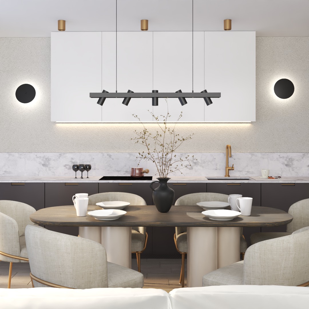 Elegancka jadalnia w nowoczesnym stylu z owalnym stołem, beżowymi krzesłami i czarnym wazonem z suchymi gałązkami na tle białych szafek kuchennych, marmurowego blatu i czarnych lamp ściennych.