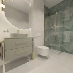 Nowoczesna łazienka z umywalką nablatową, okrągłym lustrem podświetlanym LED, kabiną prysznicową z zielonymi płytkami imitującymi marmur i złotymi detalami.