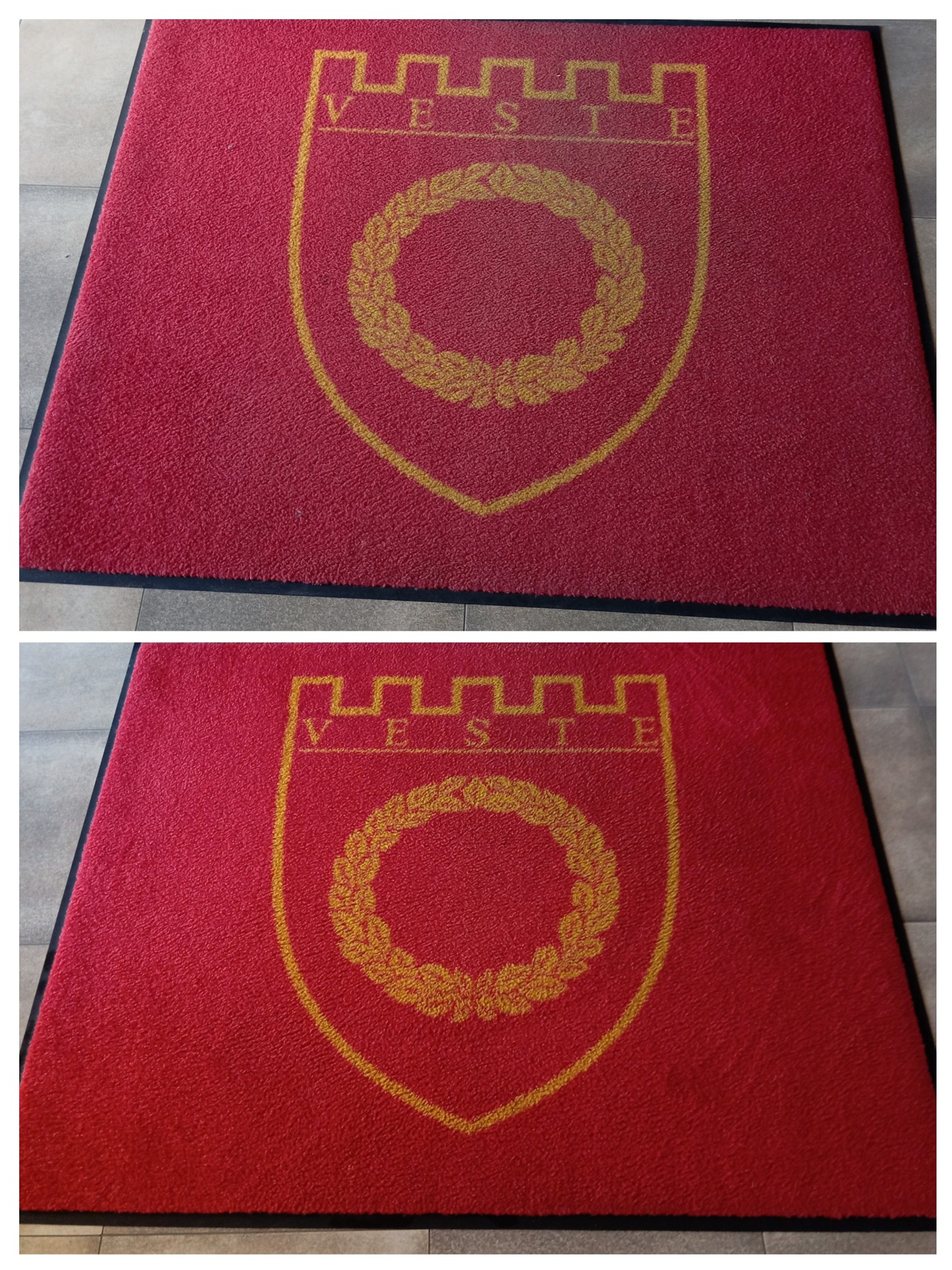 Czerwona wycieraczka wejściowa z żółtym herbem i napisem 'VESTE' na tle szarej podłogi.