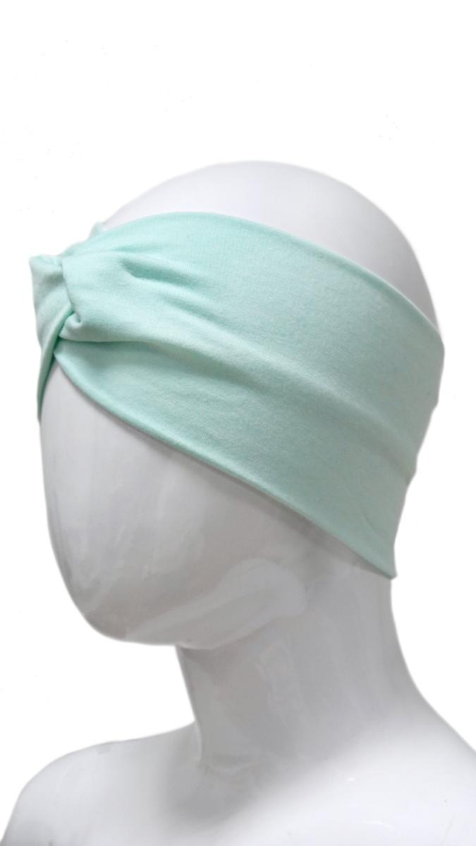 Miętowa opaska na głowę z supłem, prezentowana na białym manekinie.