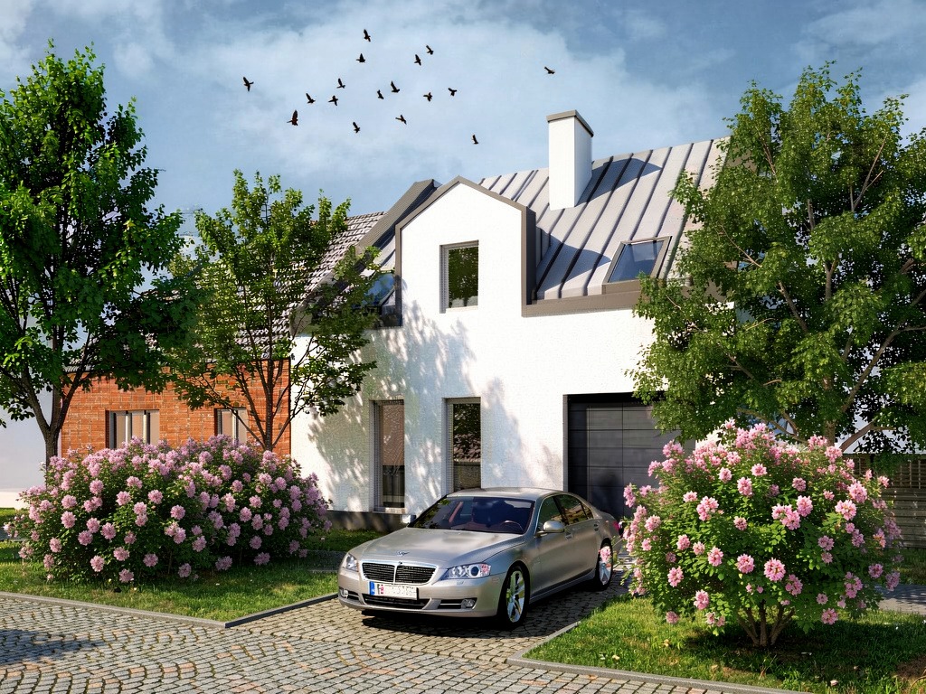Wizualizacja nowoczesnego domu z białymi ścianami, szarym dachem i garażem. Przed domem srebrny samochód i kwitnące krzewy. Na niebie klucz ptaków.