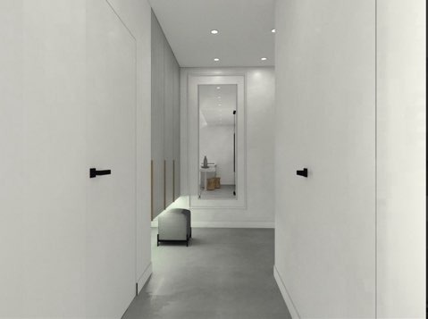 Minimalistyczny przedpokój w odcieniach bieli i szarości z czarnymi klamkami, lustrem w białej ramie i pufą.