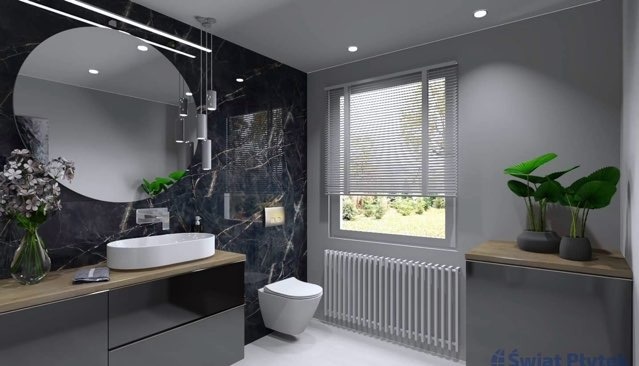 Nowoczesna łazienka z czarnymi płytkami imitującymi marmur, owalną umywalką nablatową, okrągłym lustrem z podświetleniem LED i grzejnikiem żeberkowym pod oknem.