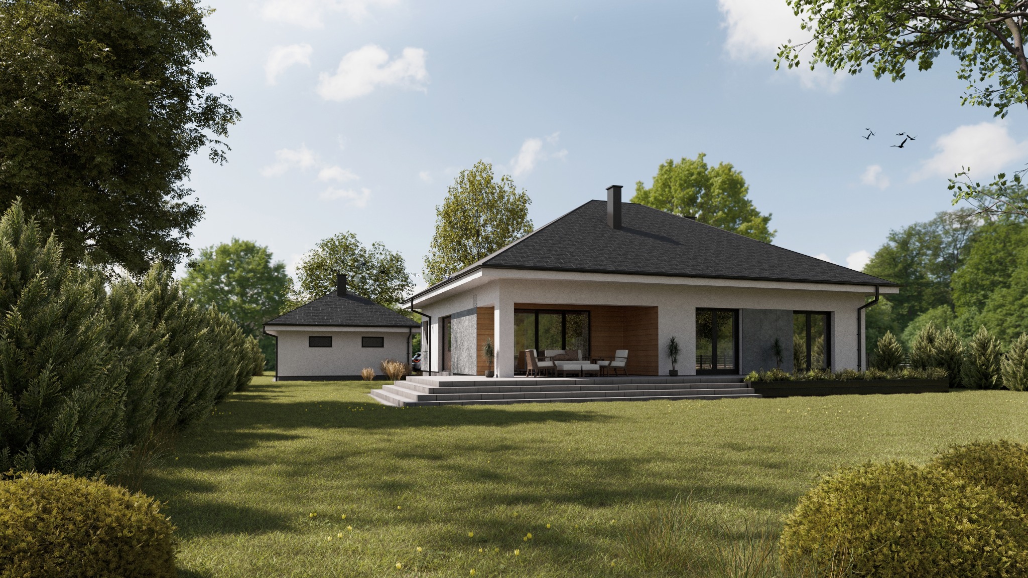Nowoczesny dom jednorodzinny z płaskim dachem i przyległym budynkiem gospodarczym, otoczony zielonym trawnikiem i drzewami w słoneczny dzień.