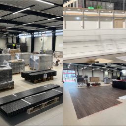 Kompleksowe Wykończenia Wnętrz - Kacper Skrzęta - Duże pomieszczenie magazynowe z paletami materiałów budowlanych, w tle montaż paneli ściennych i układanie paneli podłogowych.