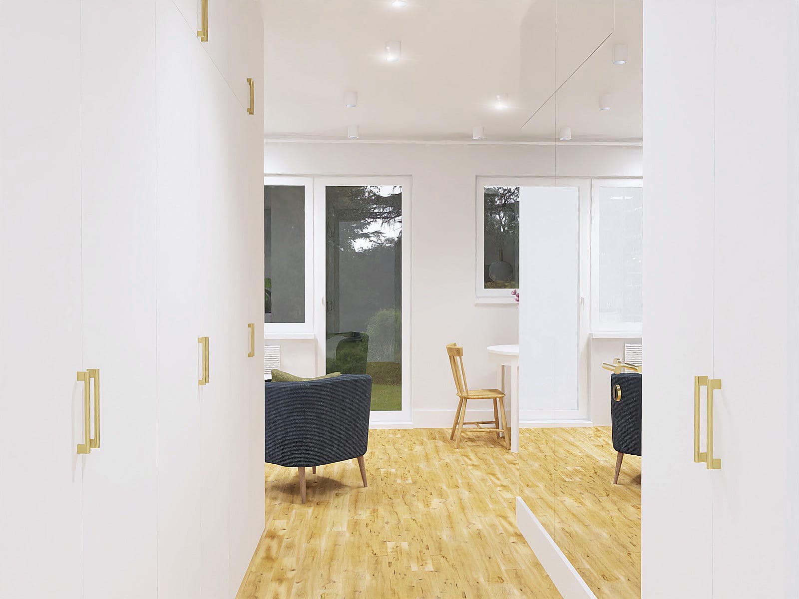 Jasne wnętrze z drewnianą podłogą, białymi ścianami i szafami z złotymi uchwytami, widok na ogród przez okno, krzesło i stolik w tle.