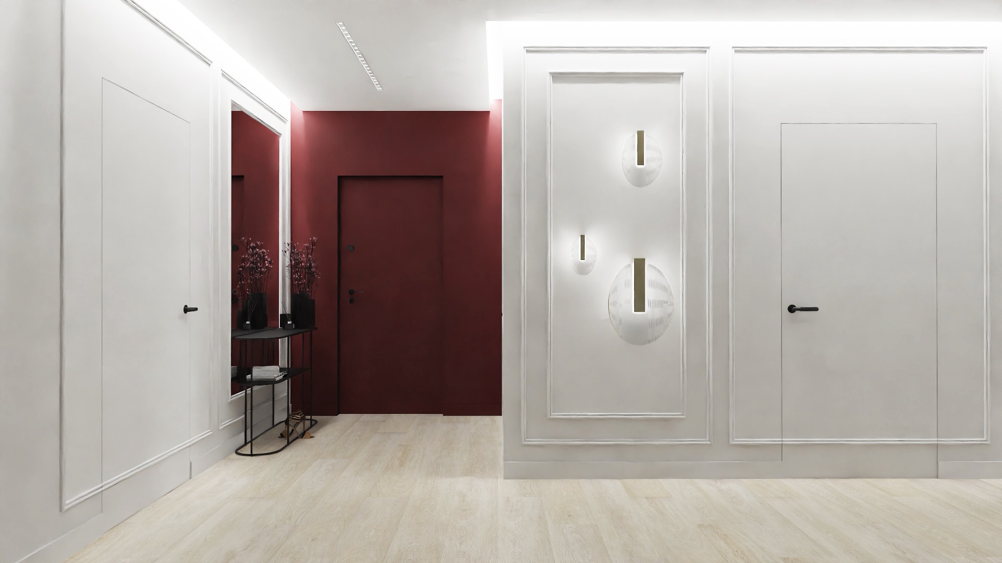 Nowoczesny przedpokój z białymi ścianami z dekoracyjnymi listwami, oświetleniem punktowym, bordową ścianą w tle, minimalistycznym stolikiem z kwiatami i ukrytymi drzwiami.
