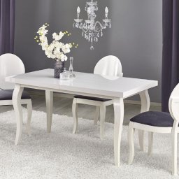 Stół rozkładany MOZART 140. Stół w stylu glamour z blatem o białym wybarwieniu w wysokim połysku. Stół można rozłożyć do 180 cm.