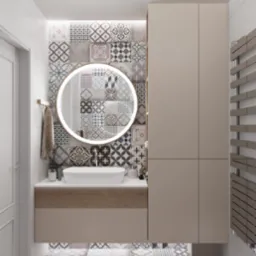 Nowoczesna łazienka z wiszącą szafką umywalkową w beżowym kolorze, okrągłym lustrem z podświetleniem LED oraz patchworkowymi płytkami na ścianie i podłodze, uzupełniona grzejnikiem drabinkowym...