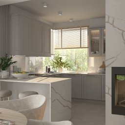 Pracownia Architektury Wnętrz Klaudia Woźniak - Jasna, nowoczesna kuchnia z wyspą, kominkiem i zasłonami, widok na zewnątrz przez okno, stół z nakryciem dla czterech osób.