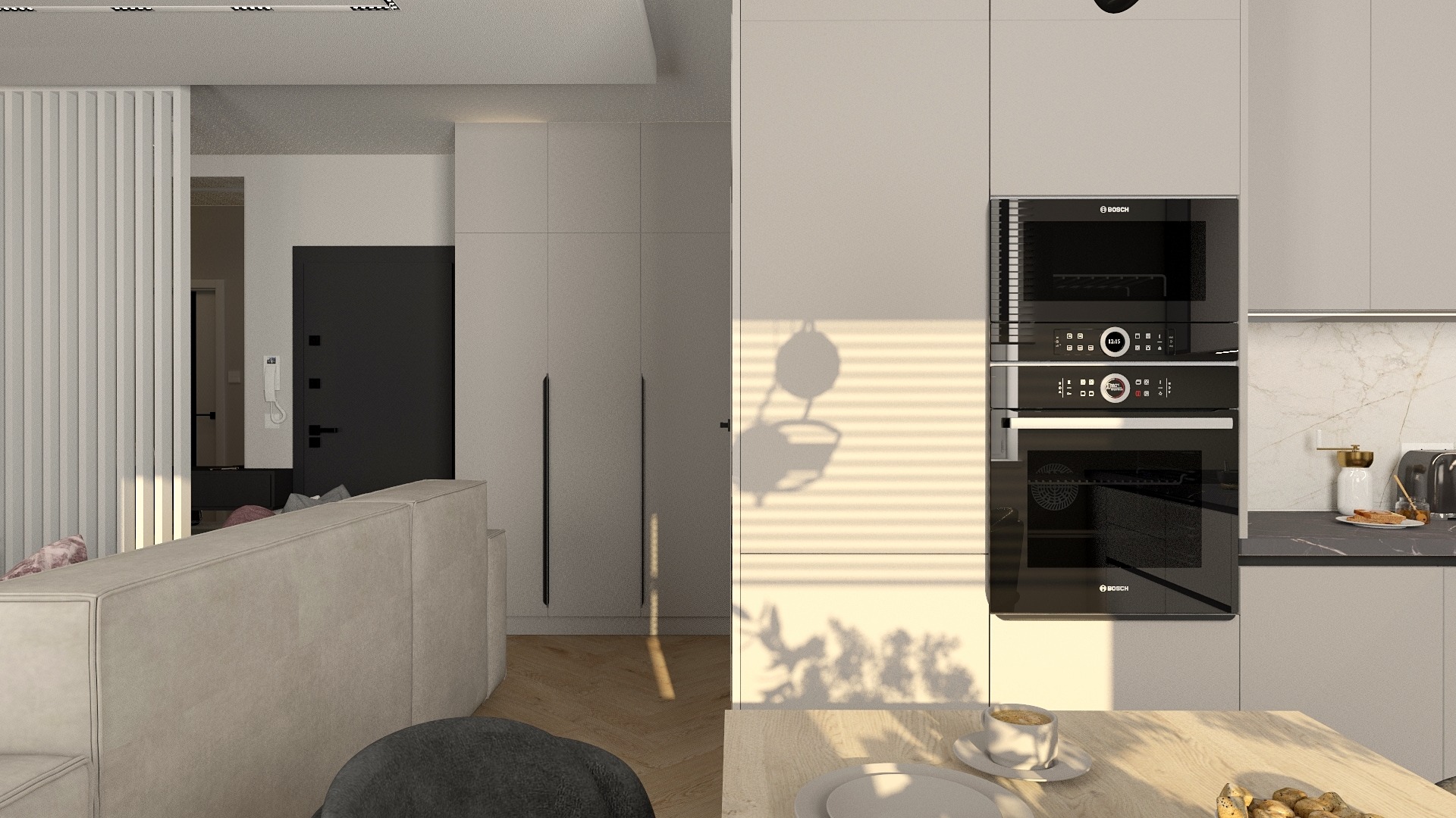 Nowoczesne wnętrze mieszkania z aneksem kuchennym, widok na zabudowę kuchenną z piekarnikiem i mikrofalówką Bosch, jasne meble i drewniana podłoga, cień rośliny na ścianie.