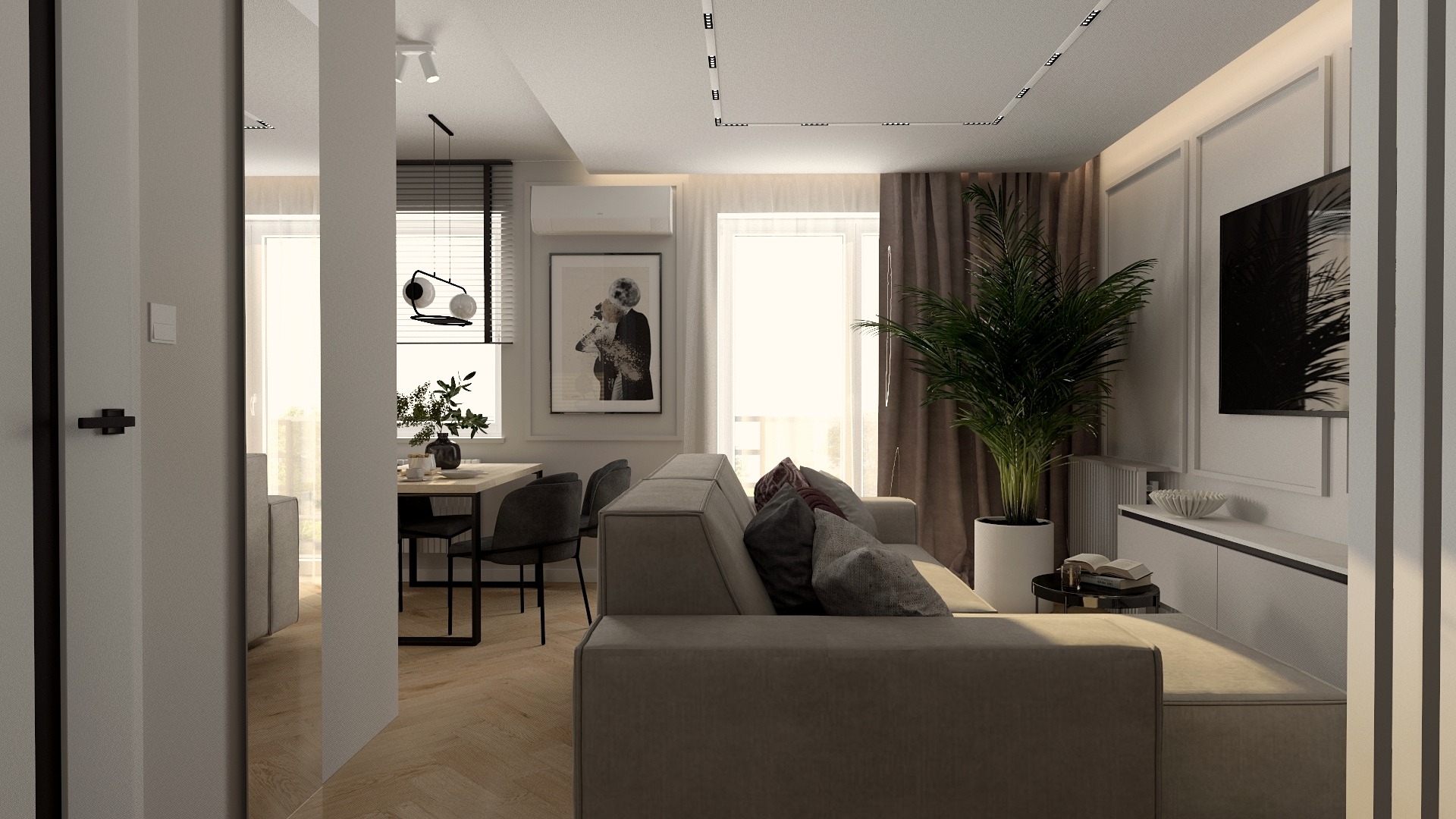 Nowoczesny salon z szarą sofą, drewnianą podłogą w jodełkę, stołem jadalnym z czarnymi krzesłami oraz dużą rośliną doniczkową obok telewizora na białej szafce. Na ścianie wisi czarno-biały plakat.