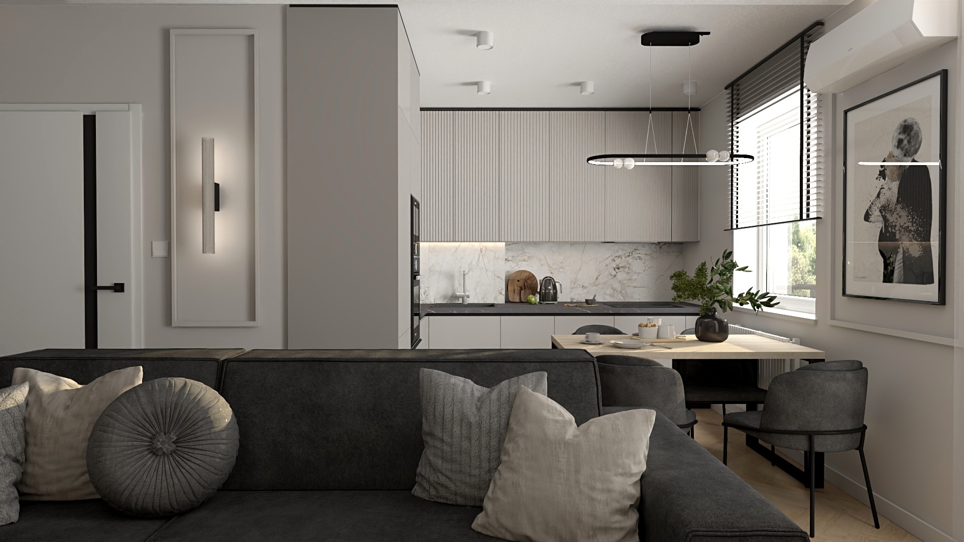 Nowoczesne wnętrze mieszkania z szarą sofą, okrągłą poduszką, aneksem kuchennym z marmurowym blatem i minimalistycznym oświetleniem, widok z perspektywy sofy.