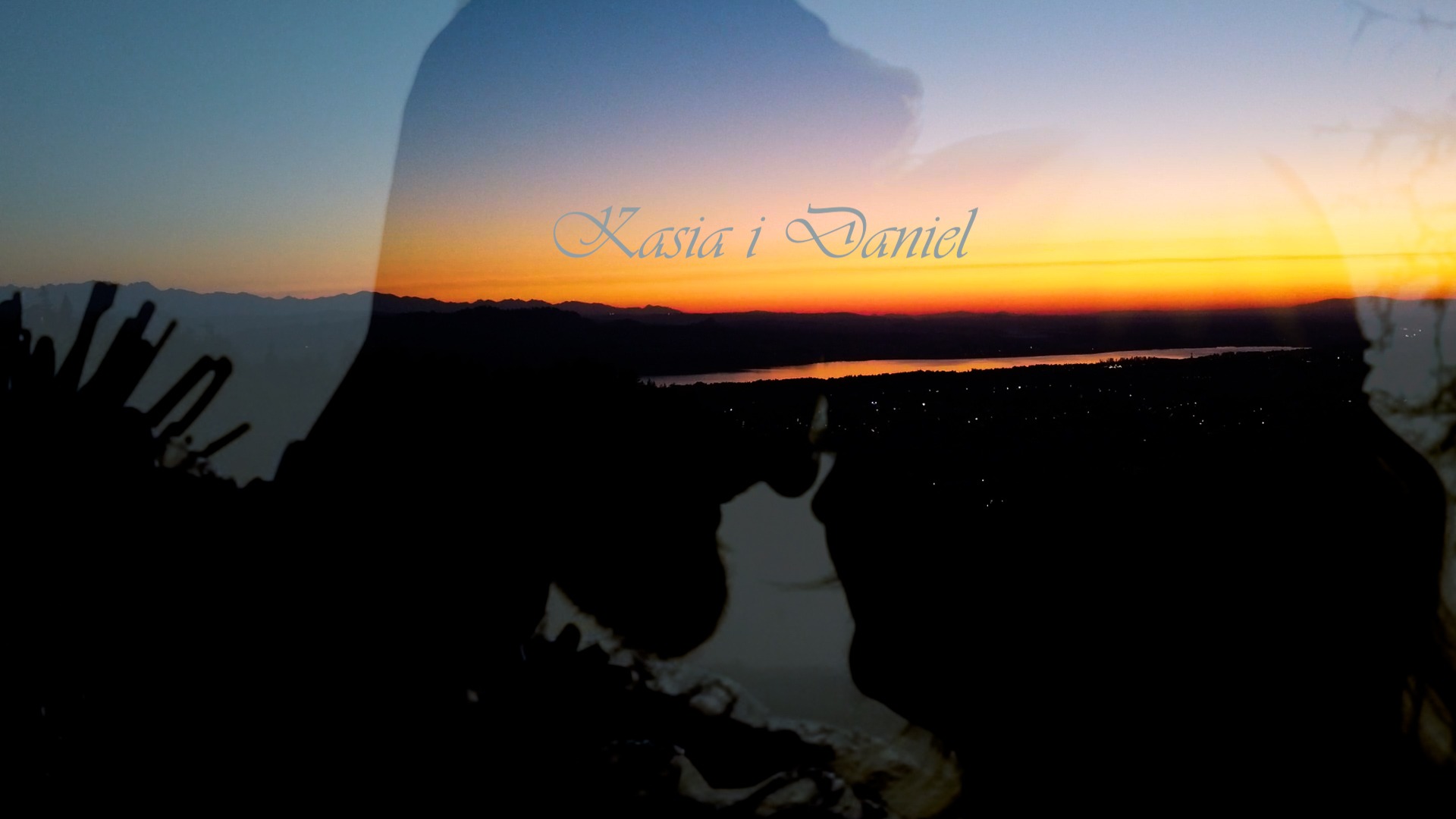 Podwójna ekspozycja: sylwetki pary na tle zachodzącego słońca nad jeziorem i górami, z delikatnym napisem 'Kasia i Daniel'.