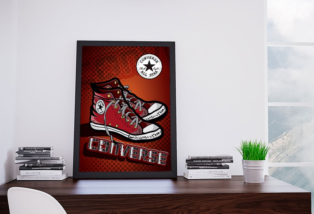 Ilustracja w ramce przedstawiająca parę czerwonych trampek Converse All Star na tle z efektem komiksowym, umieszczona na drewnianym biurku obok stosu książek i doniczki z trawą, z oknem w tle.
