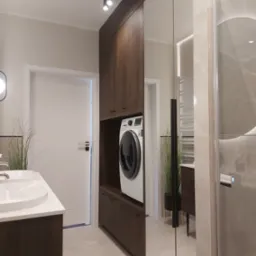 Nowoczesna łazienka z zabudową z ciemnego drewna, w której umieszczono pralkę. Umywalka z białym blatem i duże lustro optycznie powiększają przestrzeń.