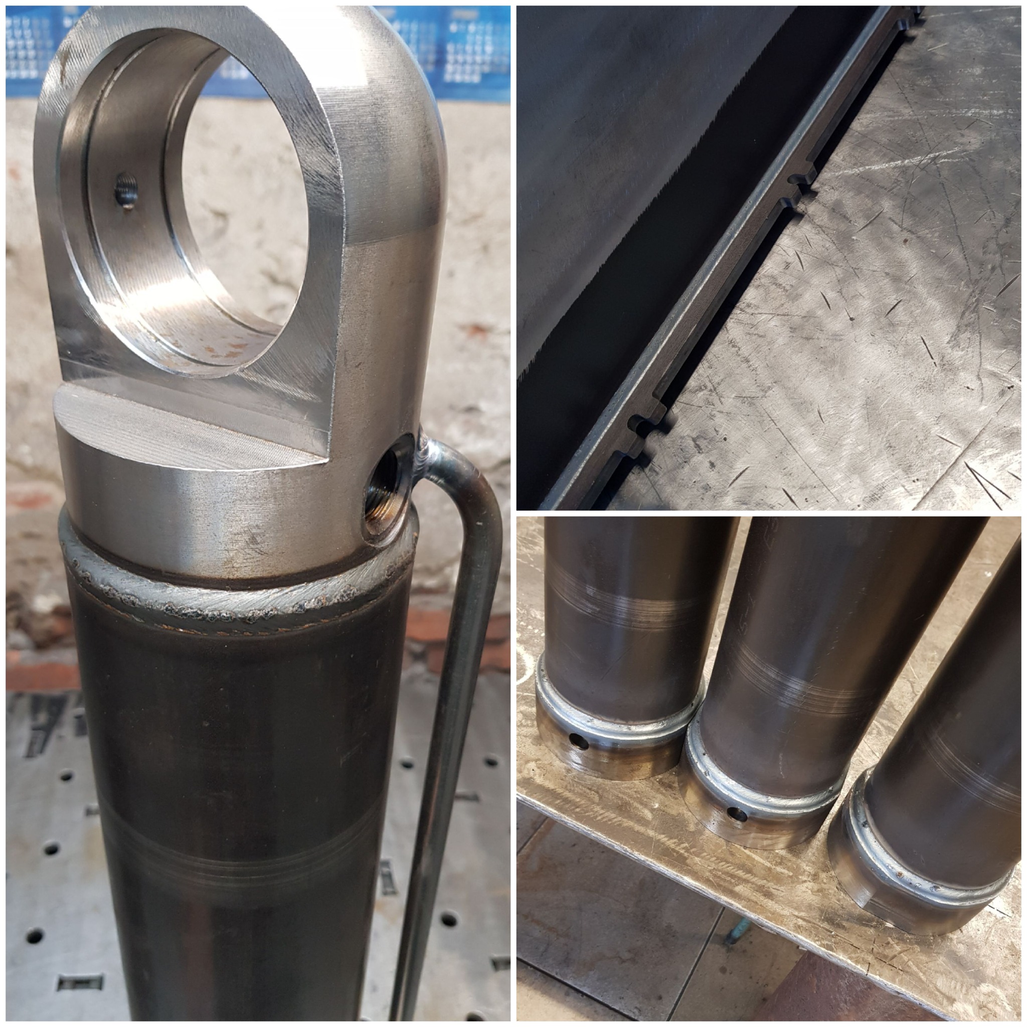 Metalowy cylinder hydrauliczny z przyspawanym uchwytem, widoczne spawy i obróbka metalu, na tle warsztatu.