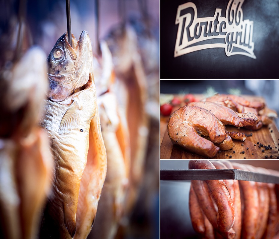 Kompozycja z wędzonych ryb wiszących na haku, grillowanych steków z łososia na desce z pomidorami i pieprzem, kiełbas na ruszcie oraz logo Route 66 Grill na ciemnym tle.