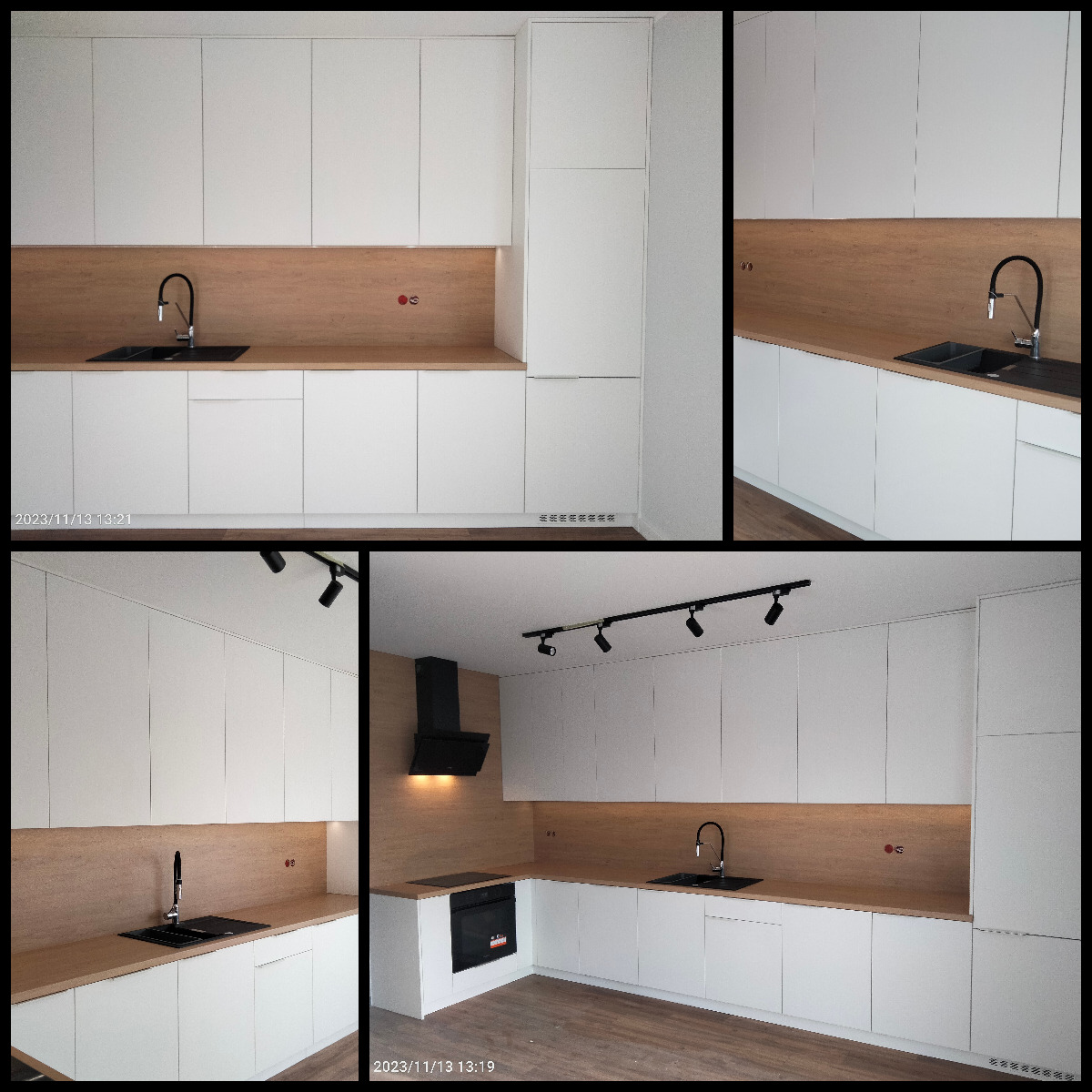 Nowoczesna, minimalistyczna kuchnia z białymi frontami szafek, drewnianym blatem i czarną armaturą, oświetlona reflektorami sufitowymi, z widocznym okapem i piekarnikiem w zabudowie.