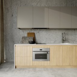 Daniela Beker Projektowanie Wnętrz - Minimalistyczna kuchnia z drewnianymi frontami, betonową ścianą, wiszącymi szafkami z oświetleniem LED, wbudowanym piekarnikiem Miele i marmurową deską do krojenia w tle.