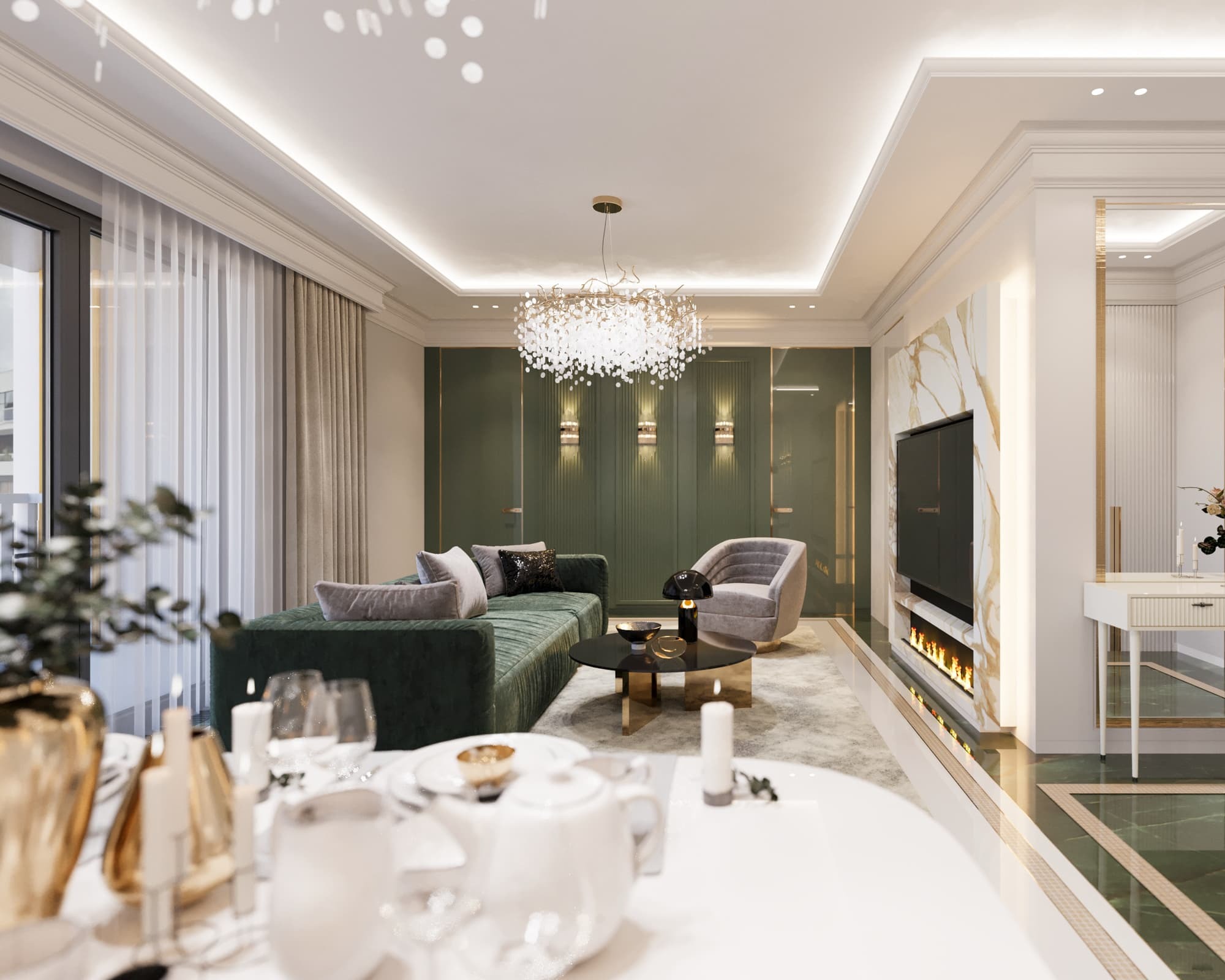 Elegancki salon z zielonymi akcentami, kanapą z aksamitną tapicerką, okrągłym stolikiem kawowym i dekoracyjnym żyrandolem, fragment zastawionego stołu na pierwszym planie.