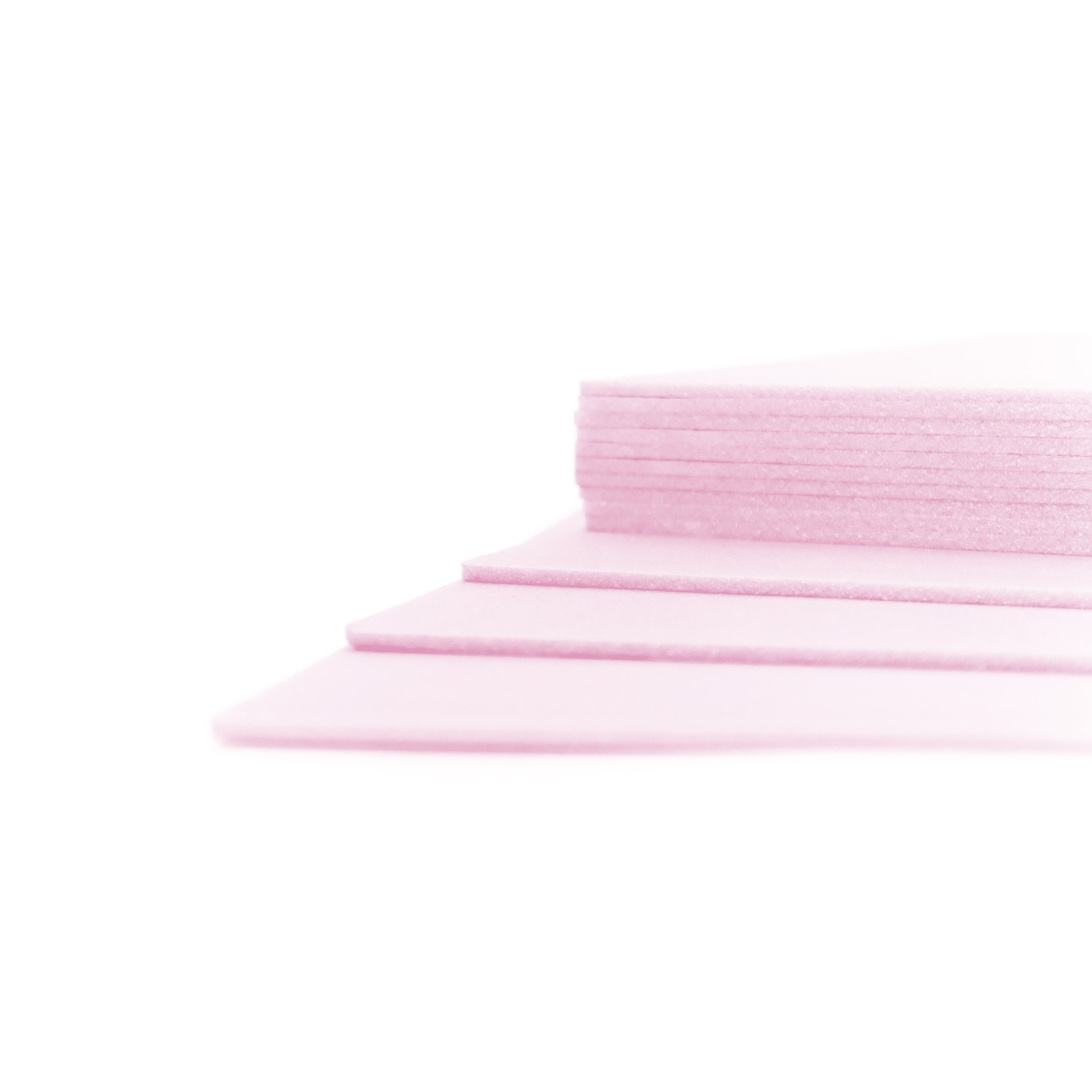 Różowe płyty XPS ułożone warstwowo, przeznaczone do izolacji podłogowej pod panele, z widoczną strukturą materiału.