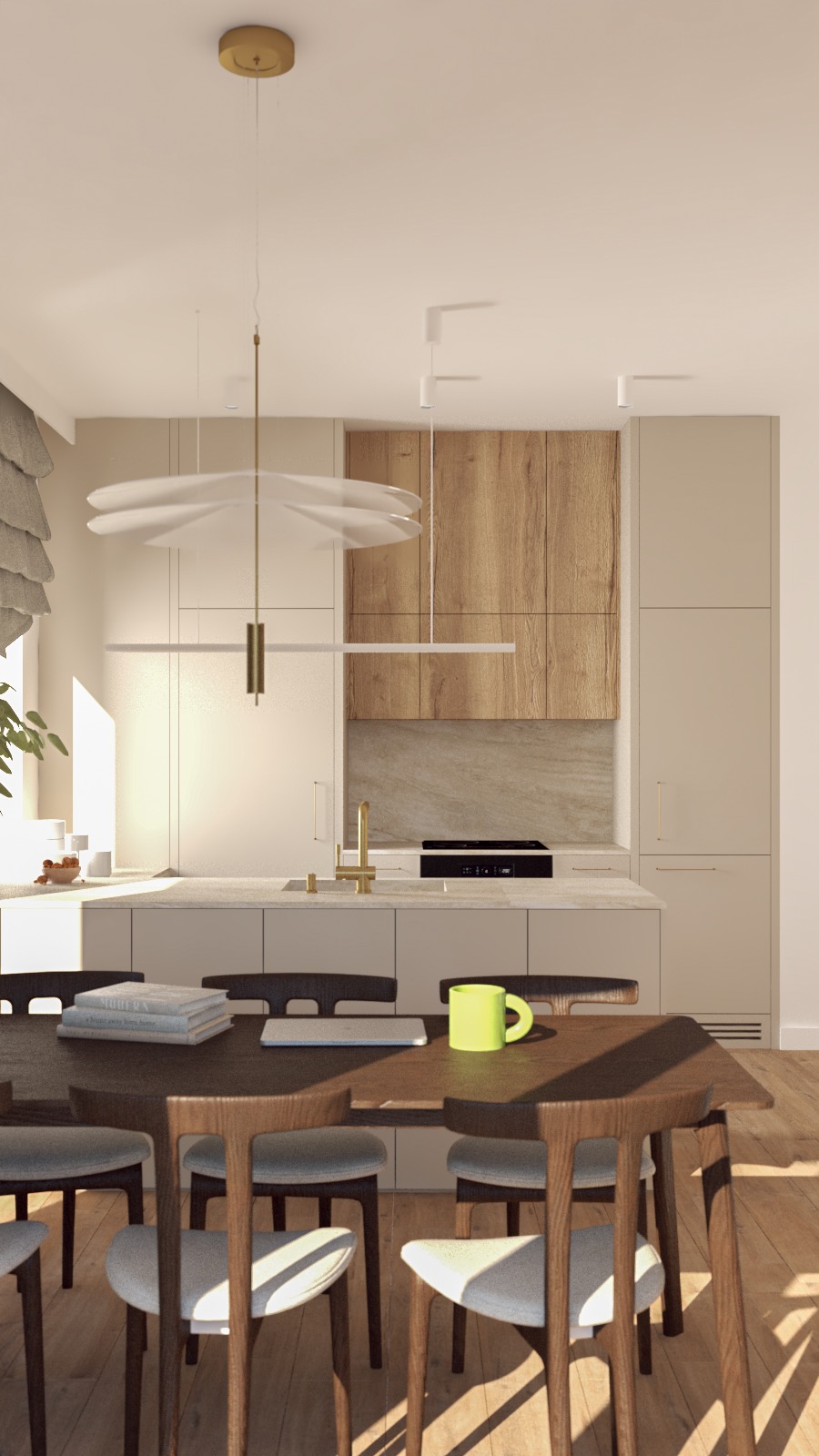 Jasna kuchnia z drewnianymi akcentami, widoczny stół z krzesłami, laptop, książki i neonowy kubek, oświetlona nowoczesną lampą wiszącą.
