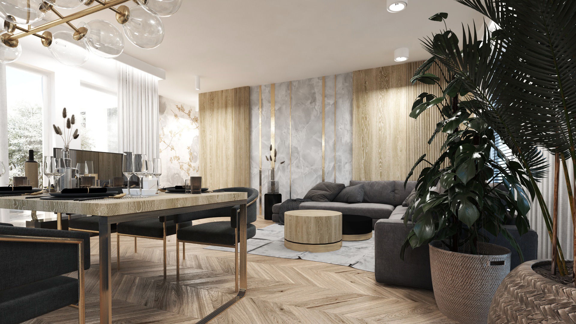 Jasne wnętrze z drewnianą podłogą w jodełkę, stół z nakryciem, szary narożnik, drewniane panele ścienne z marmurowymi wstawkami i dużymi roślinami doniczkowymi.