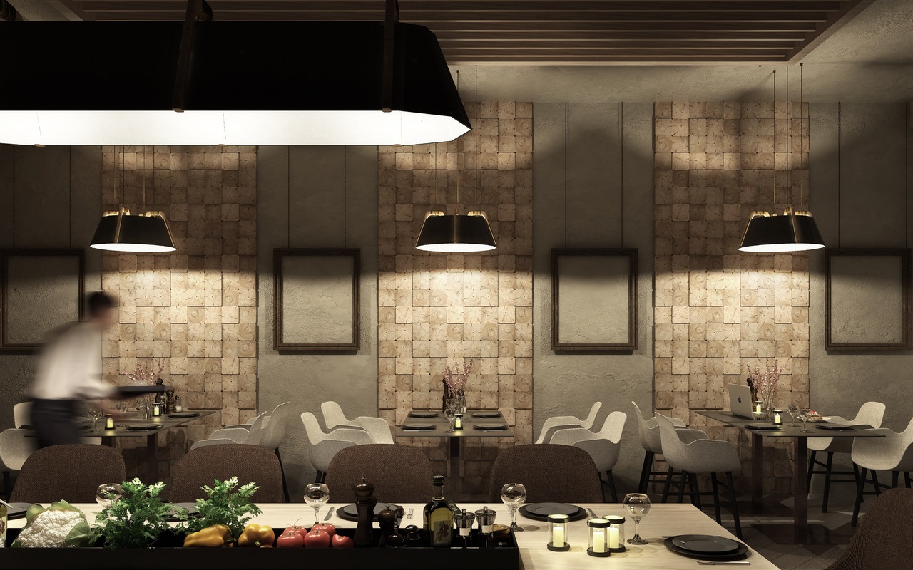 Elegancka restauracja z dekoracyjną ścianą z drewnianych kostek, nowoczesnymi lampami wiszącymi i stołami z nakryciem, kelner w tle.