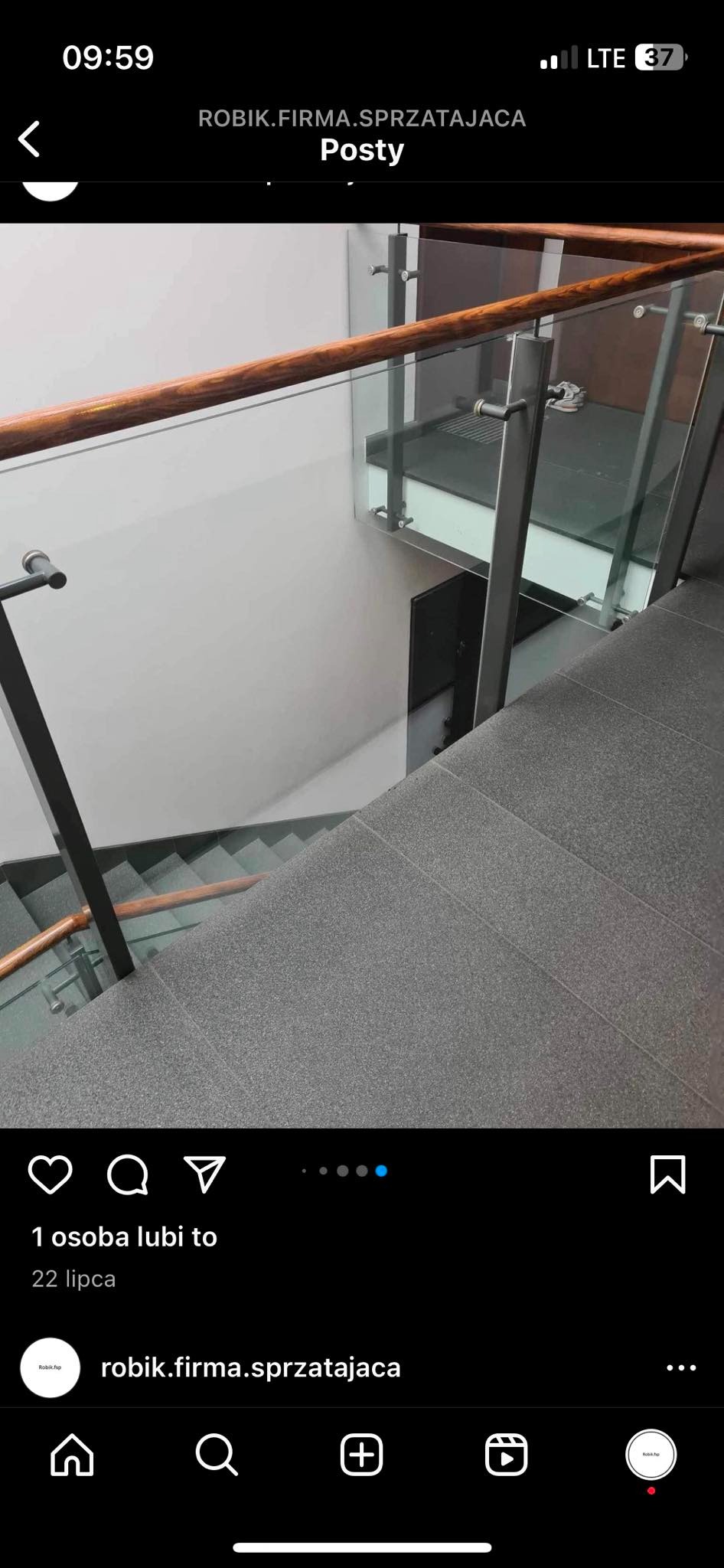 Schody w biurze z szarymi stopniami i szklaną balustradą z drewnianym poręczą, widok z góry po sprzątaniu.