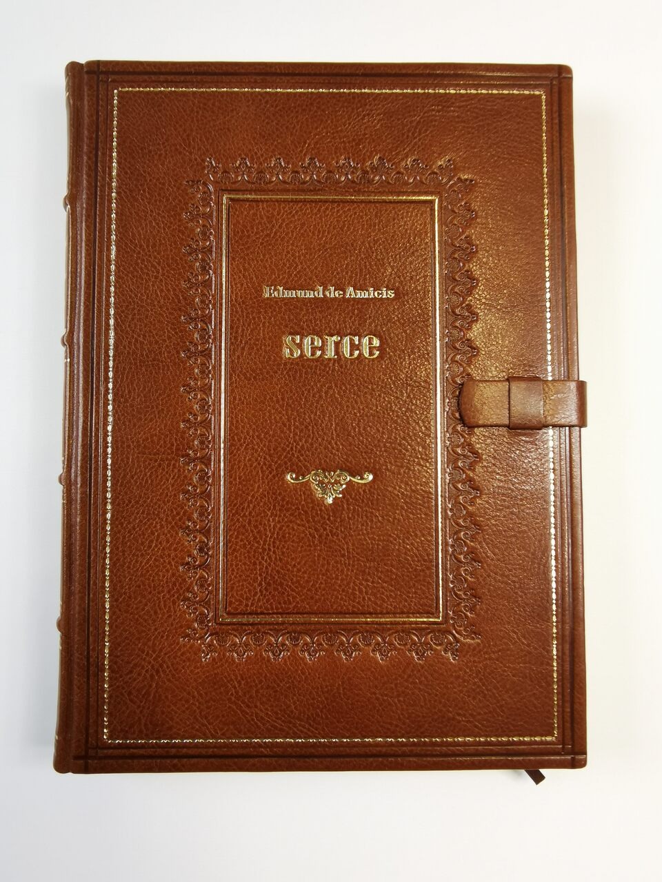 Książka pt. Serce Edmunda de Amicisa w skórzanej oprawie zamykanej szlufką. Tłoczenia ręczne i złocenia.