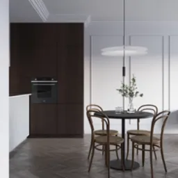 Minimalistyczna kuchnia z ciemnymi szafkami, parkietem w jodełkę i okrągłym stołem z krzesłami Thonet, oświetlona nowoczesną lampą wiszącą.