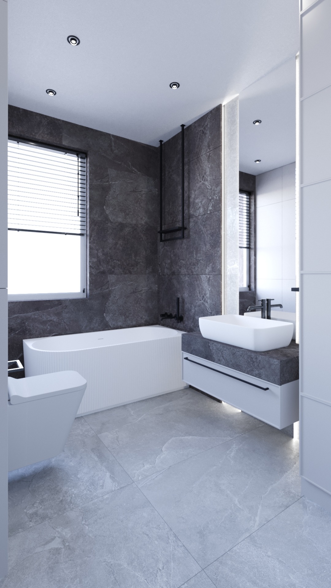 Nowoczesna łazienka z wanną, umywalką nablatową i szarą okładziną imitującą kamień, uzupełniona o czarne akcenty armatury i minimalistyczne oświetlenie.