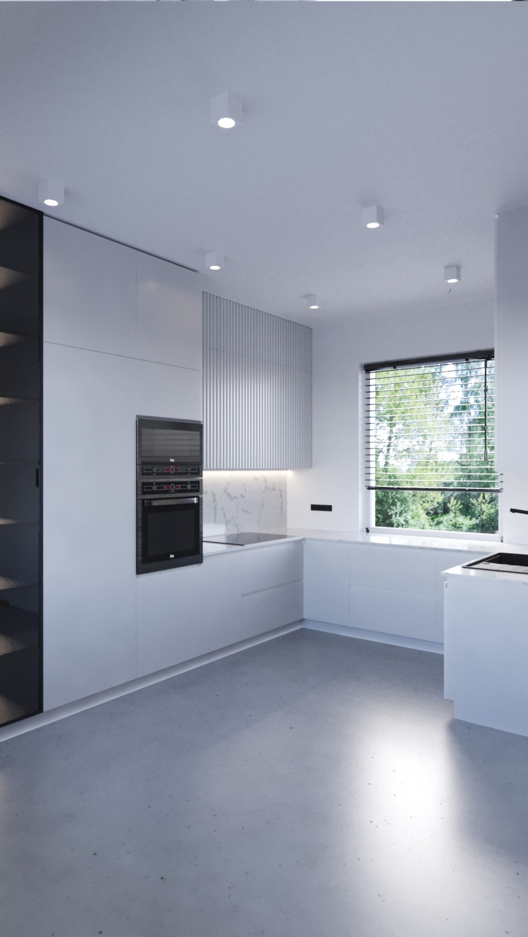 Minimalistyczna, nowoczesna kuchnia w bieli z zabudową kuchenną, piekarnikiem i mikrofalówką w zabudowie, marmurowym blatem i szarym betonowym podłożem w dobrze oświetlonym wnętrzu.