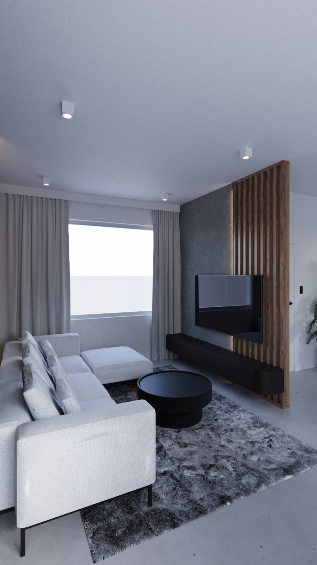 Nowoczesny salon z narożną sofą w odcieniach bieli, czarnym okrągłym stolikiem kawowym i telewizorem na ścianie z dekoracyjnymi drewnianymi lamelami.