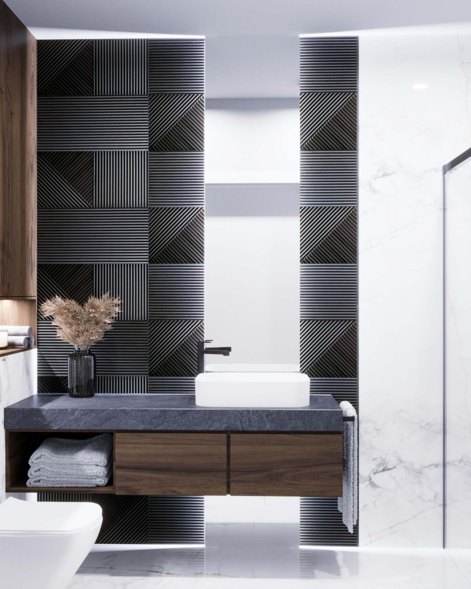 Nowoczesna łazienka z geometryczną ścianą, umywalką nablatową i drewnianą szafką pod umywalką, uzupełniona o wazon ze suszem i marmurowe wykończenie ścian.
