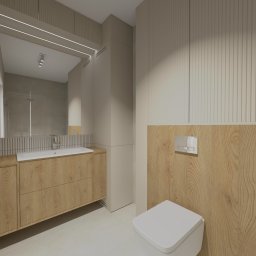 Fiolet Studio Klaudia Lis- Kowalska - Wizualizacja łazienki w stonowanych beżach z drewnianymi akcentami: szafka pod umywalką z dwiema szufladami, toaleta wisząca z drewnianą obudową spłuczki, lustro z oświetleniem LED.