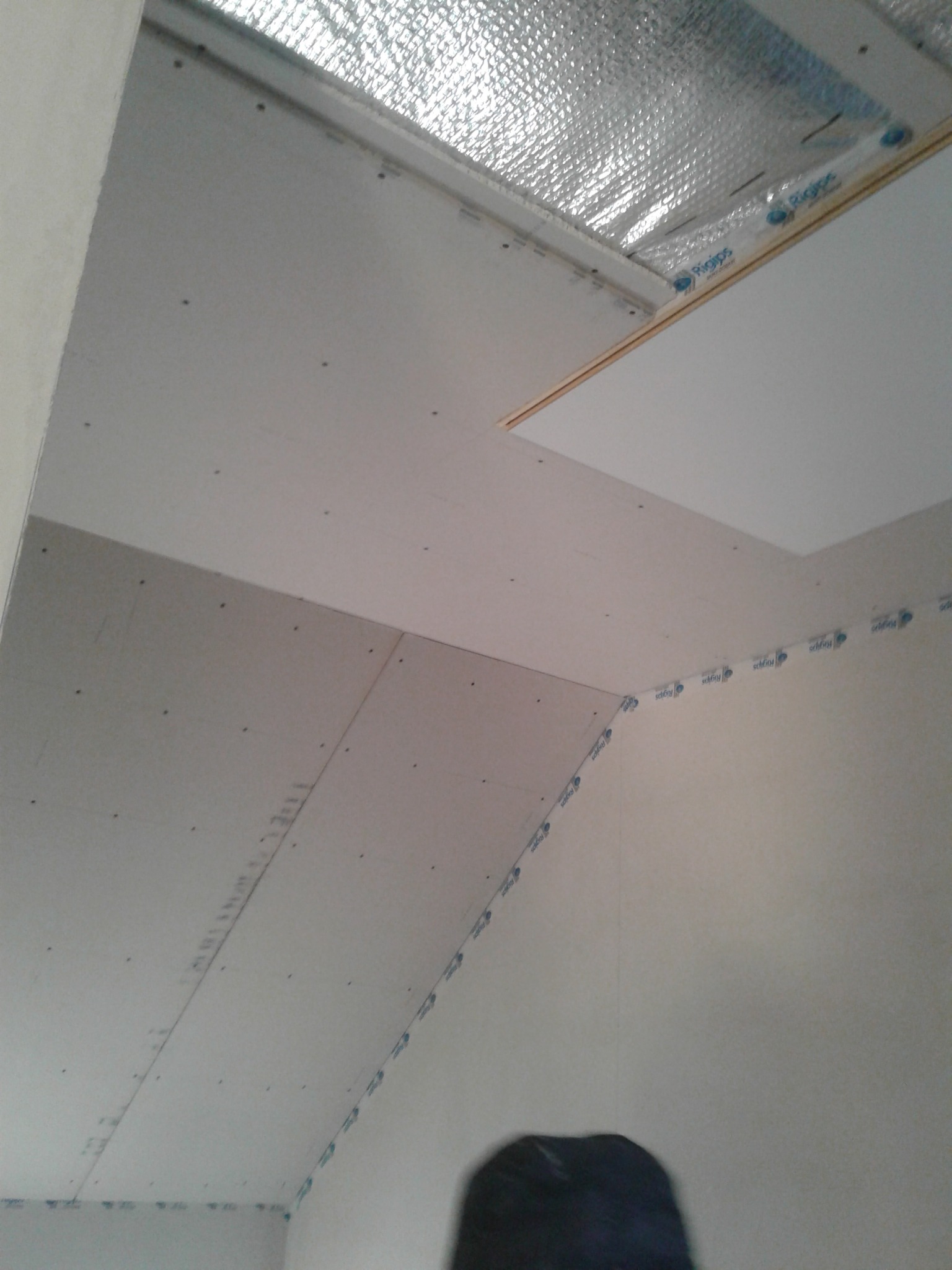 Płyty gipsowo-kartonowe zamontowane na poddaszu, widoczne profile i izolacja termiczna, przygotowanie do dalszych prac wykończeniowych.