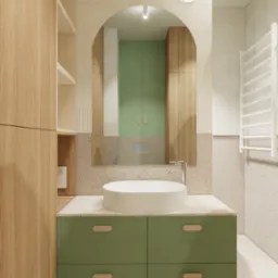 Nowoczesna łazienka z zieloną szafką pod umywalką, okrągłą białą umywalką nablatową i lustrem w łuku, oświetlona lampą sufitową, z widocznymi płytkami imitującymi lastryko na podłodze i ścianach.