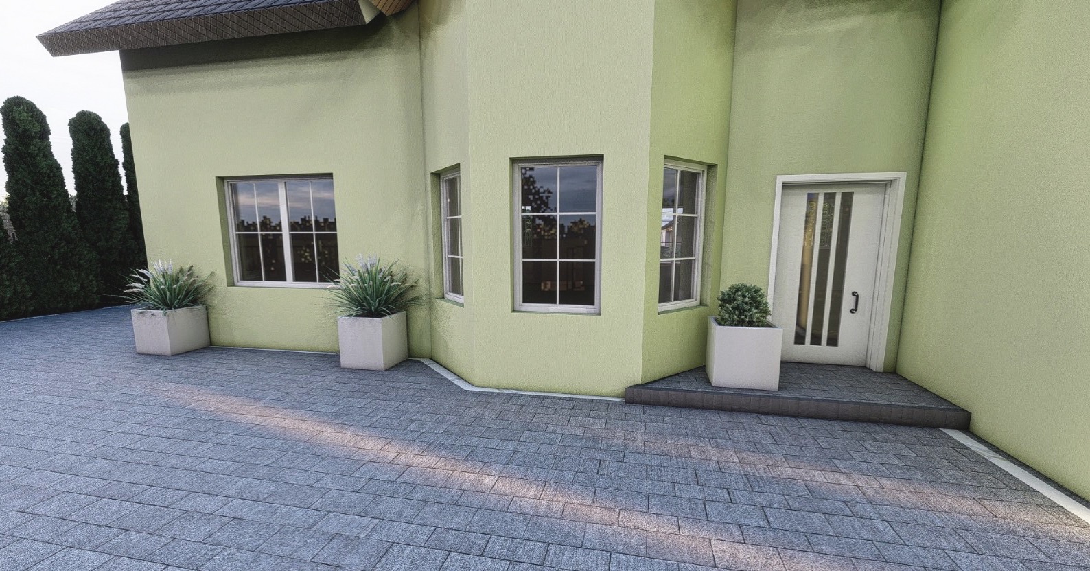 Wejście do domu z jasną elewacją, wyłożone szarą kostką brukową, z trzema białymi donicami z roślinami ozdobnymi.