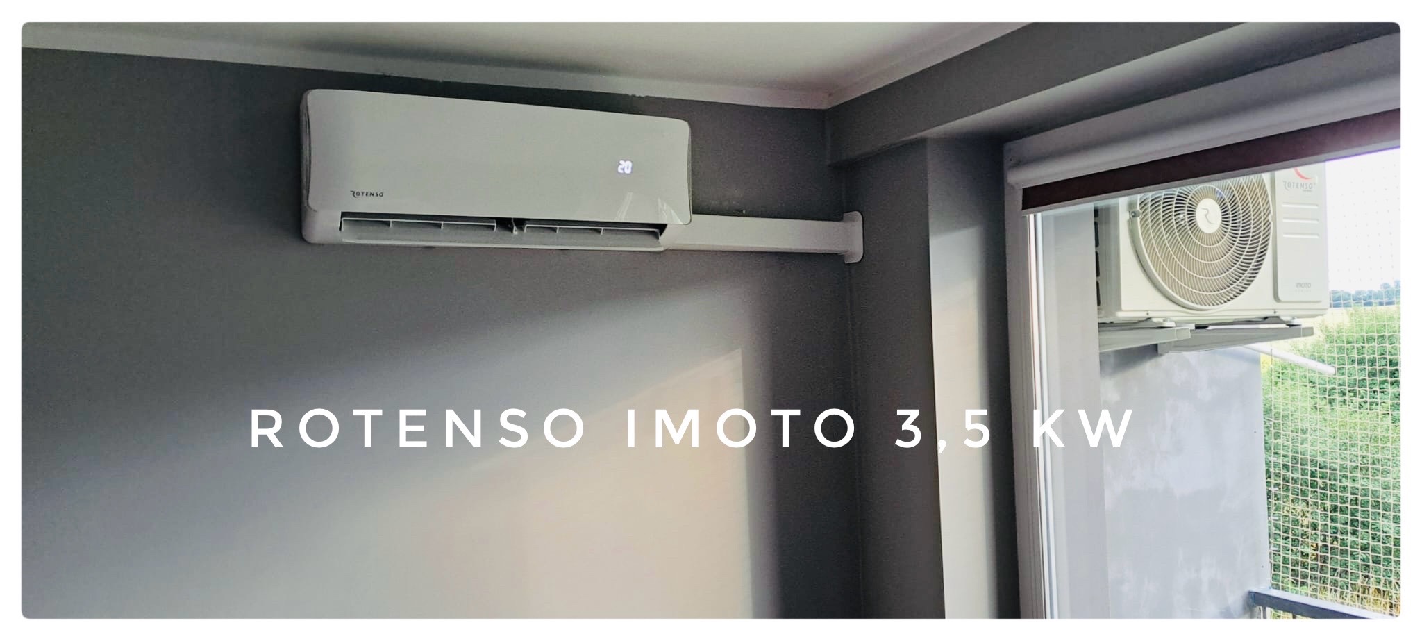 Zamontowany klimatyzator Rotenso IMOTO 3,5 kW na szarej ścianie w pomieszczeniu, z widocznym wyświetlaczem temperatury ustawionym na 20 stopni Celsjusza oraz jednostka zewnętrzna za oknem.