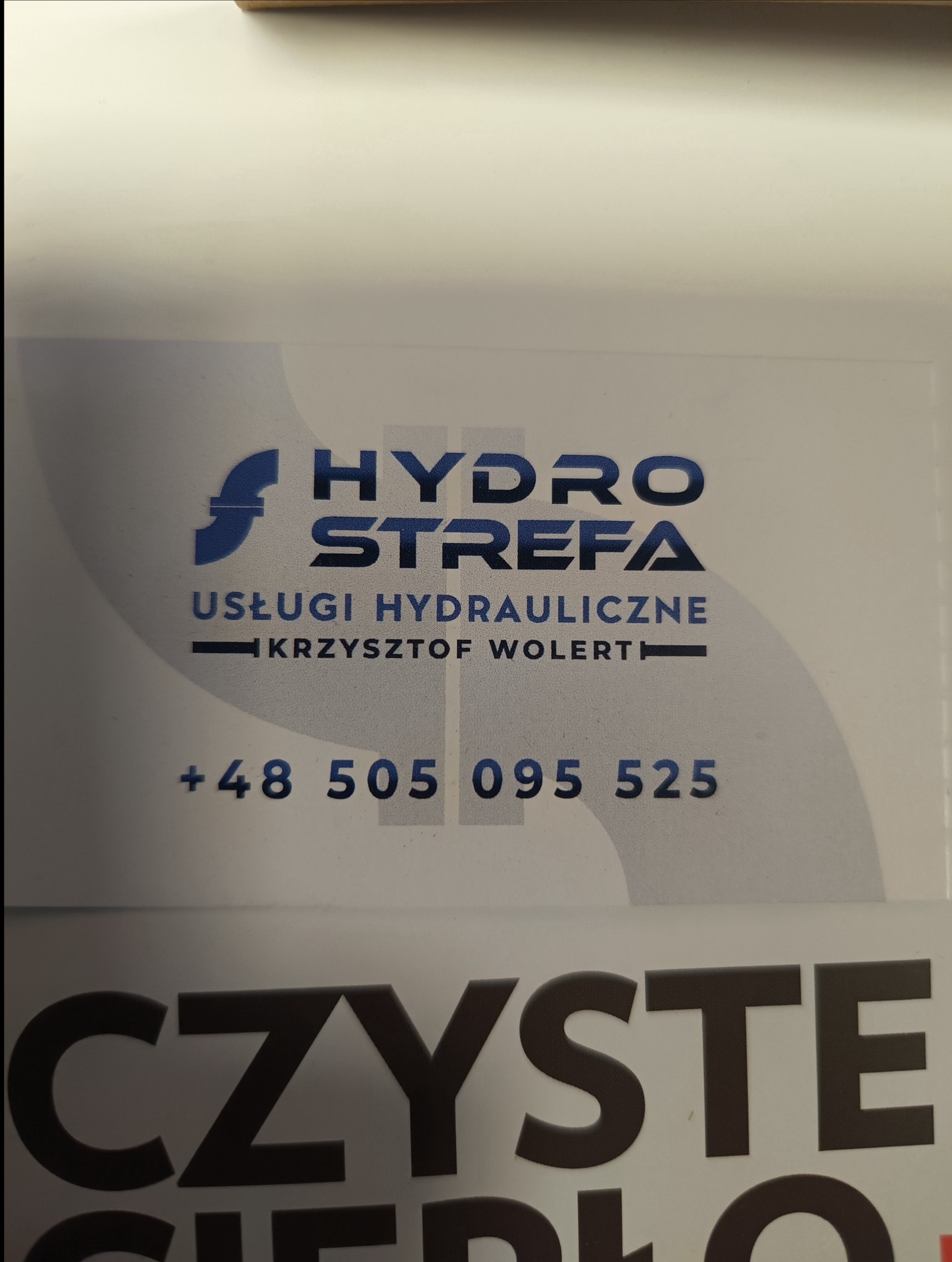Wizytówka firmy Hydro Strefa z numerem telefonu i nazwą Krzysztof Wolert oferującej usługi hydrauliczne.