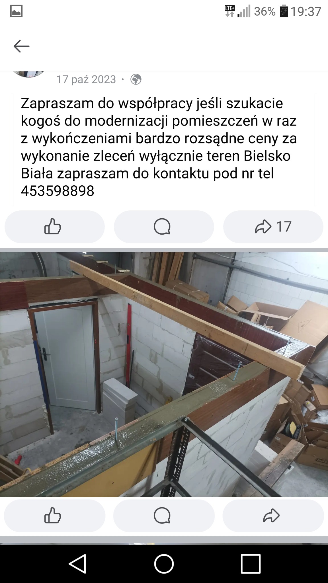 Wnętrze w trakcie prac remontowych: ściany z bloczków, drewniana konstrukcja sufitu, widoczne narzędzia i materiały budowlane, drzwi wejściowe z białą ościeżnicą.