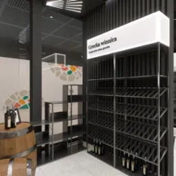 Wizualizacja sklepu z winami 'Grecka winnica', prezentująca regały na butelki wina, drewnianą beczkę jako stolik ekspozycyjny z butelkami i ramką, oraz elementy dekoracyjne na ścianach.