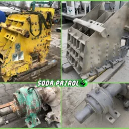 Kolaż przedstawiający elementy maszyny budowlanej: żółty korpus z widocznymi śladami rdzy, szary element konstrukcyjny oraz dwa detale wału z łożyskami, jeden zielony i zardzewiały, drugi szary.